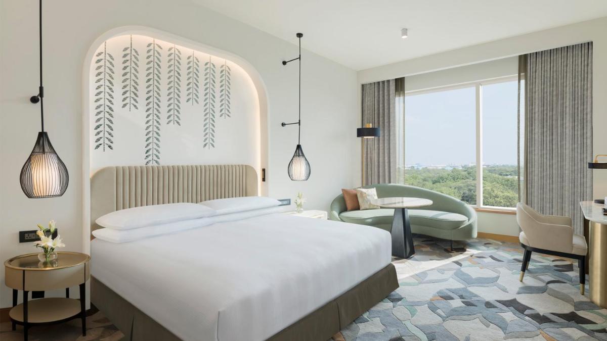 a hotel room with a bed and a chair at InterContinental Jaipur Tonk Road by IHG in Jaipur