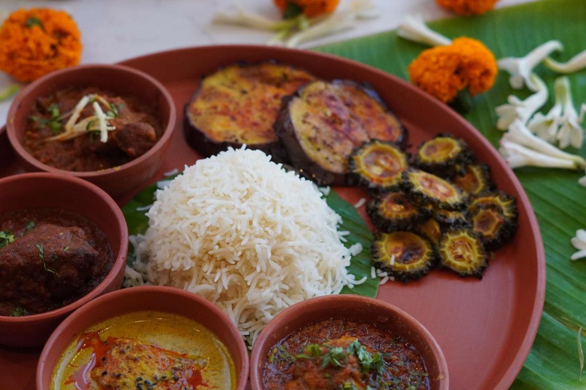 a plate of food with rice and different types of food at Radisson RED Chandigarh Mohali in Chandīgarh