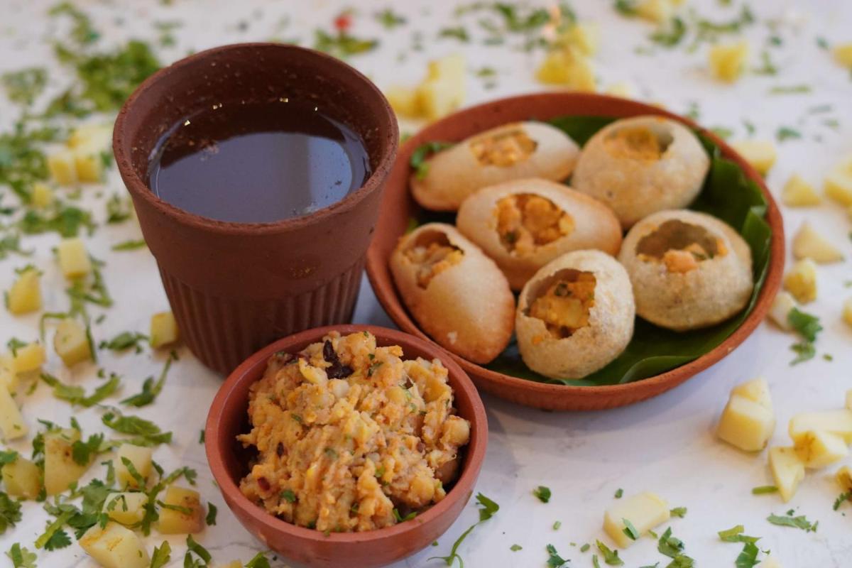 a table with bowls of food and a cup of coffee at Radisson RED Chandigarh Mohali in Chandīgarh