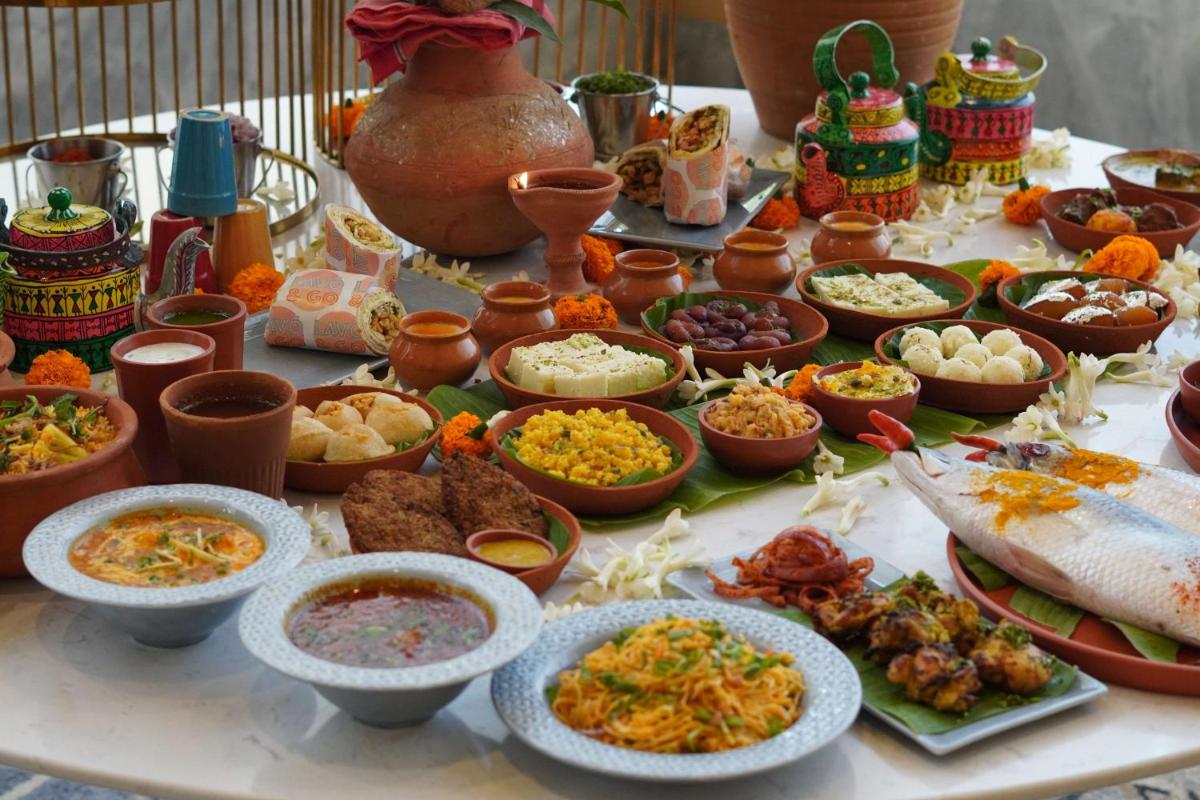 a table topped with lots of different types of food at Radisson RED Chandigarh Mohali in Chandīgarh
