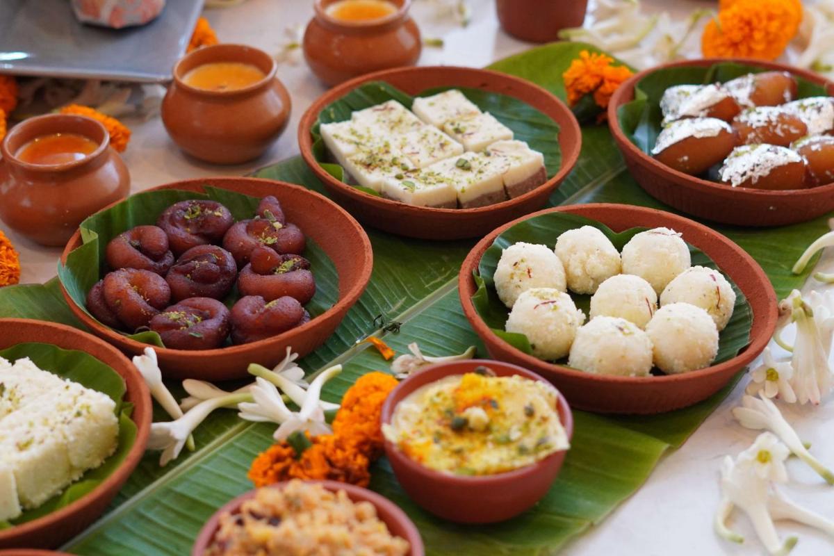 a table topped with bowls of food on a banana leaf at Radisson RED Chandigarh Mohali in Chandīgarh