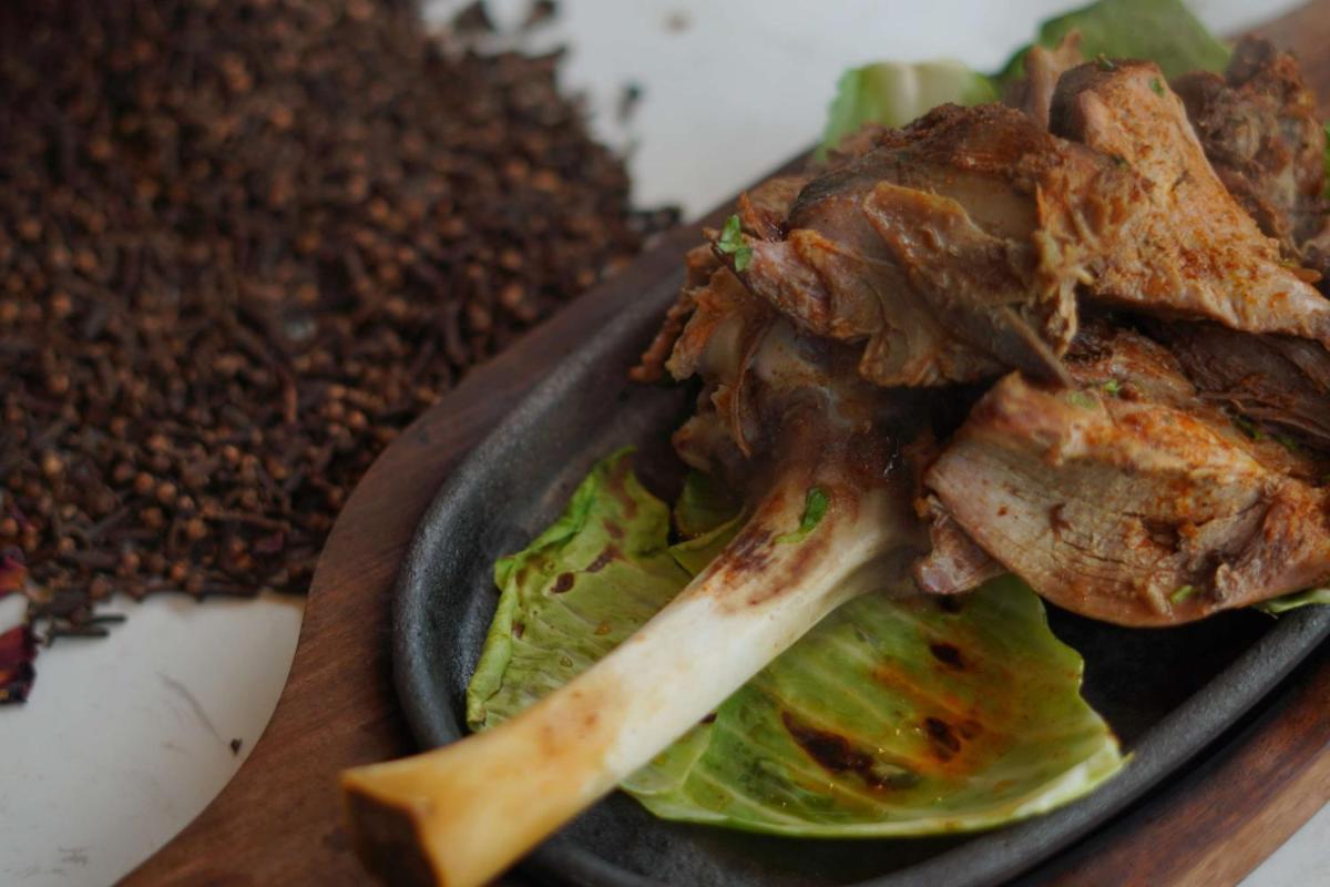 a plate of food with meat and lettuce at Radisson RED Chandigarh Mohali in Chandīgarh