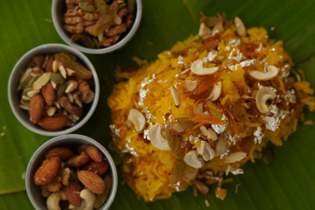 a plate of food with nuts and rice on a banana leaf at Radisson RED Chandigarh Mohali in Chandīgarh