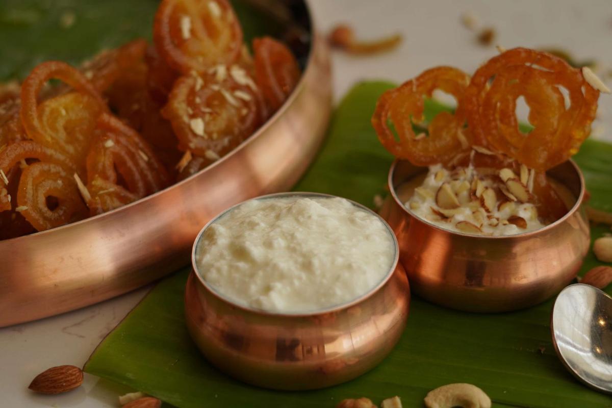 a plate of food with a bowl of dip and pretzels at Radisson RED Chandigarh Mohali in Chandīgarh