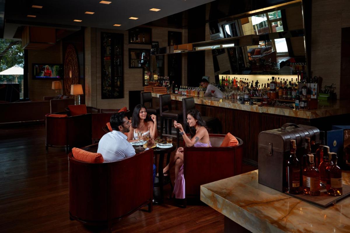 a group of people sitting at a bar at Hyatt Regency Pune Hotel & Residences in Pune