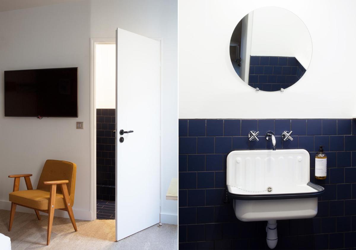 Télévision ou salle de divertissement dans l'établissement Hôtel La Nouvelle République & Hammam