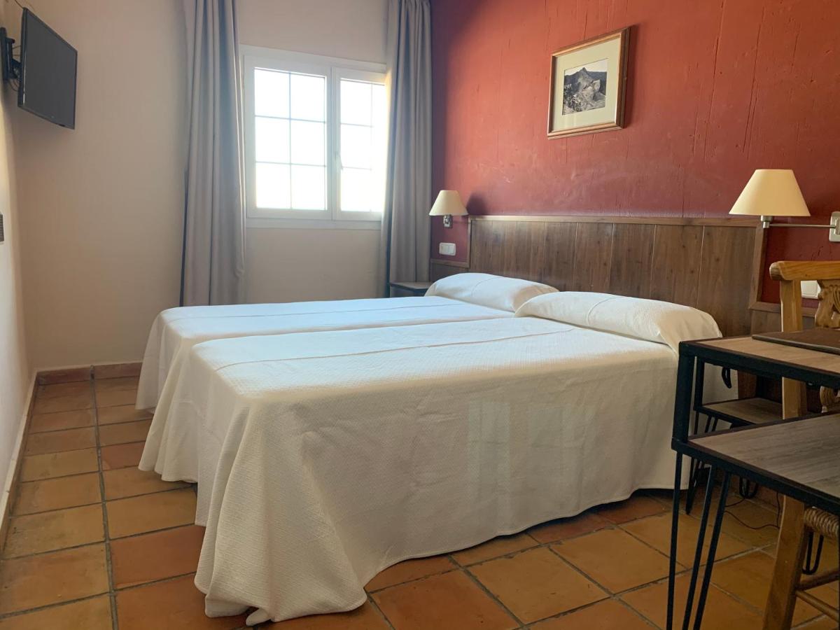 Cama o camas de una habitación en Hotel GHM Monachil