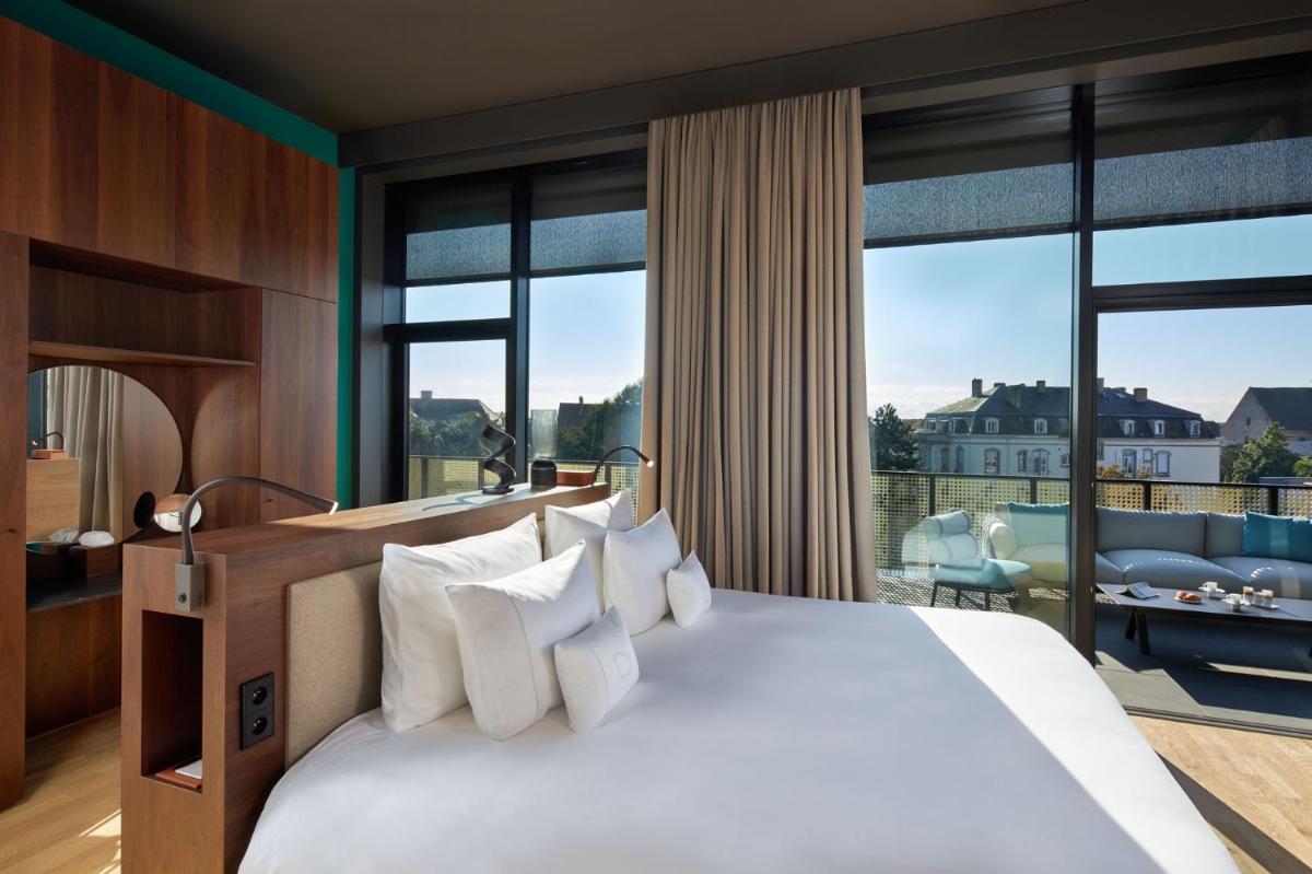 Un ou plusieurs lits dans un hébergement de l'établissement L'Esquisse Hotel & Spa Colmar - MGallery Collection