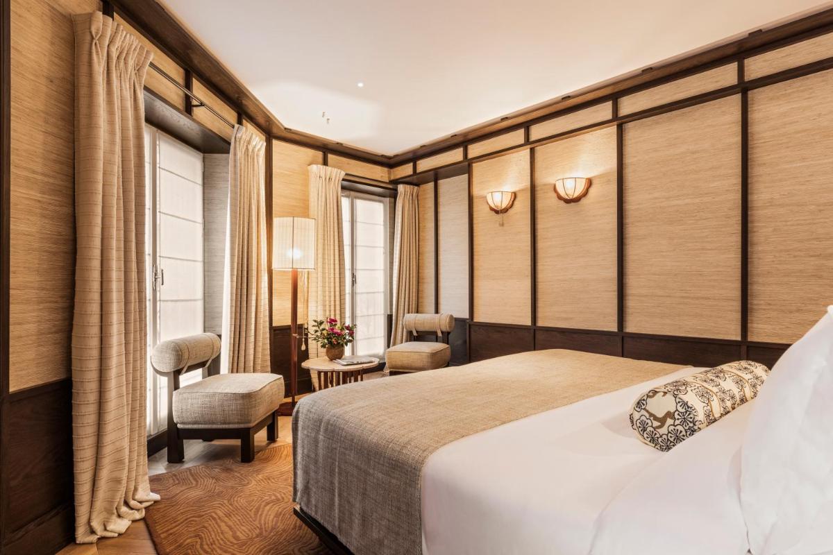 une chambre d'hôtel avec un lit et une chaise dans l'établissement Hotel Hana, à Paris