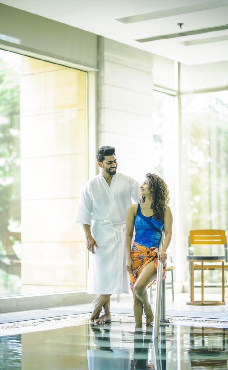 a man and a woman standing in front of a building at Hyatt Regency Pune Hotel & Residences in Pune