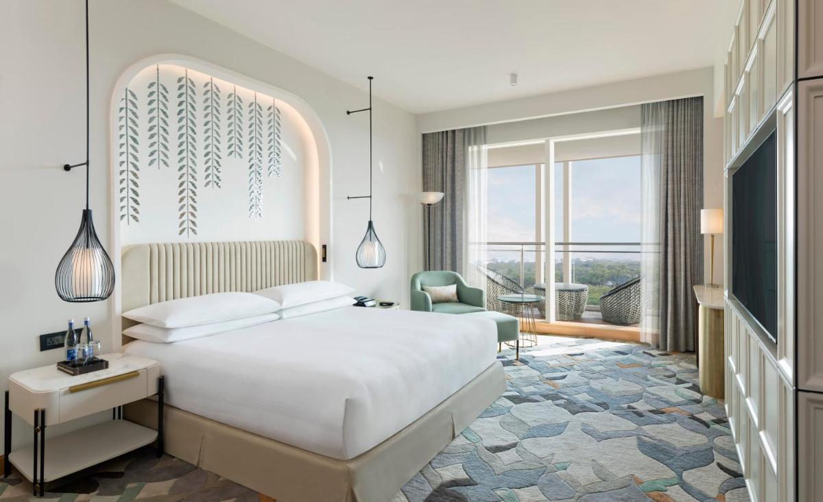 a bedroom with a white bed and a large window at InterContinental Jaipur Tonk Road by IHG in Jaipur