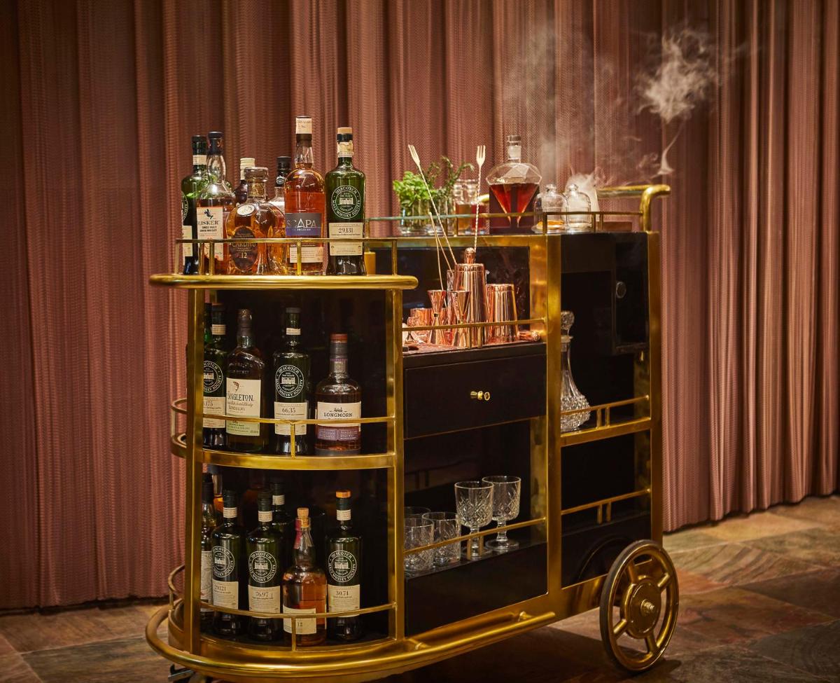 a cart filled with lots of bottles of alcohol at JW Marriott Mumbai Juhu in Mumbai