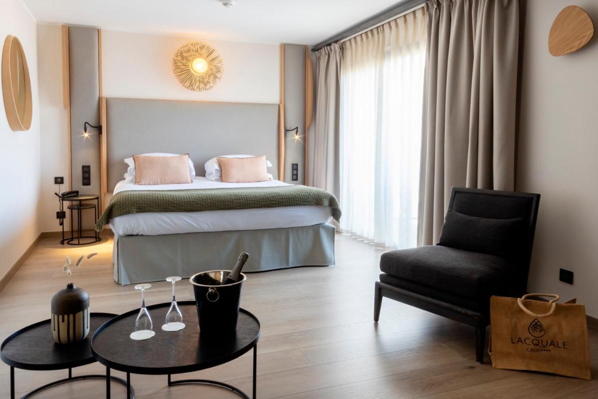 Un ou plusieurs lits dans un hébergement de l'établissement Hotel L'Acquale