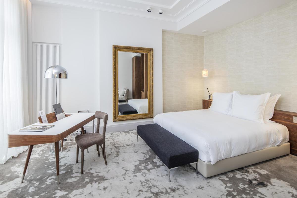 Un ou plusieurs lits dans un hébergement de l'établissement Yndo Hôtel
