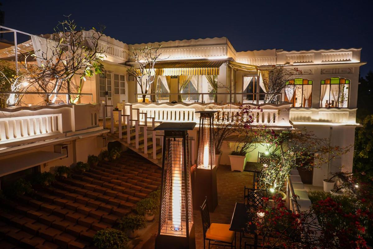 an image of a house at night with lights at Saraca Hotel Lucknow in Lucknow