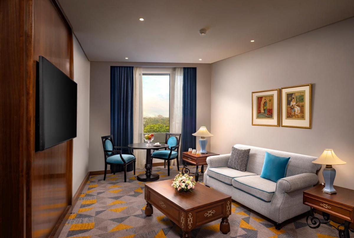 a living room with a couch and a table at Welcomhotel by ITC Hotels, Cathedral Road, Chennai in Chennai