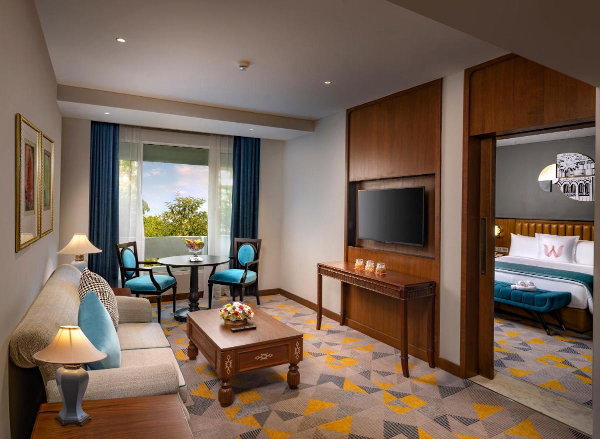 a hotel room with a bed and a living room at Welcomhotel by ITC Hotels, Cathedral Road, Chennai in Chennai