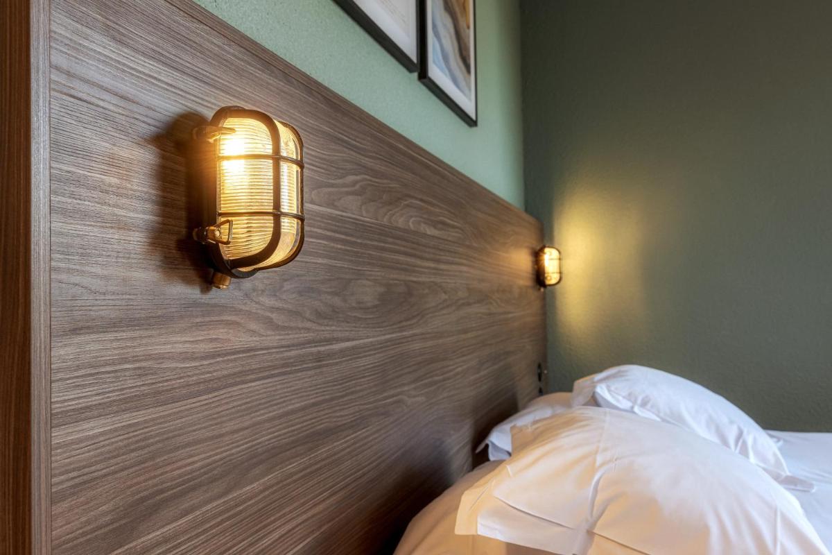 Un ou plusieurs lits dans un hébergement de l'établissement La Maison OBONO Hôtel & Spa