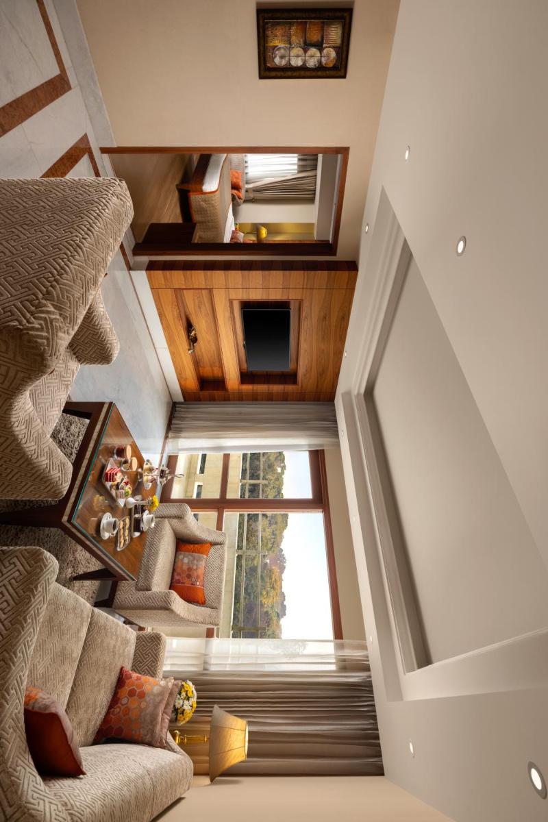 an overhead view of a living room with a staircase at Jaypee Vasant Continental in New Delhi