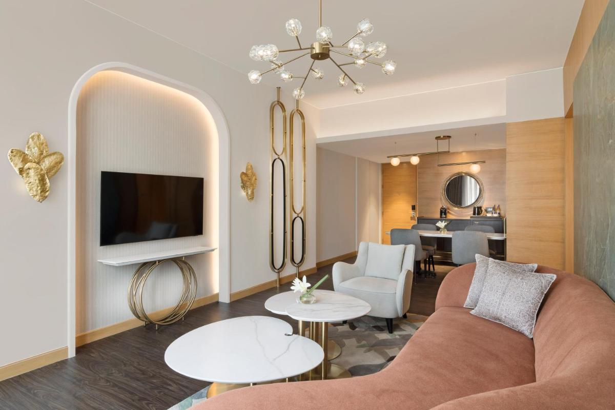a living room with a couch and a tv at InterContinental Jaipur Tonk Road by IHG in Jaipur