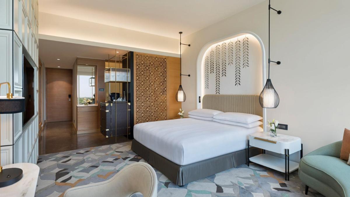 a bedroom with a bed and a living room at InterContinental Jaipur Tonk Road by IHG in Jaipur