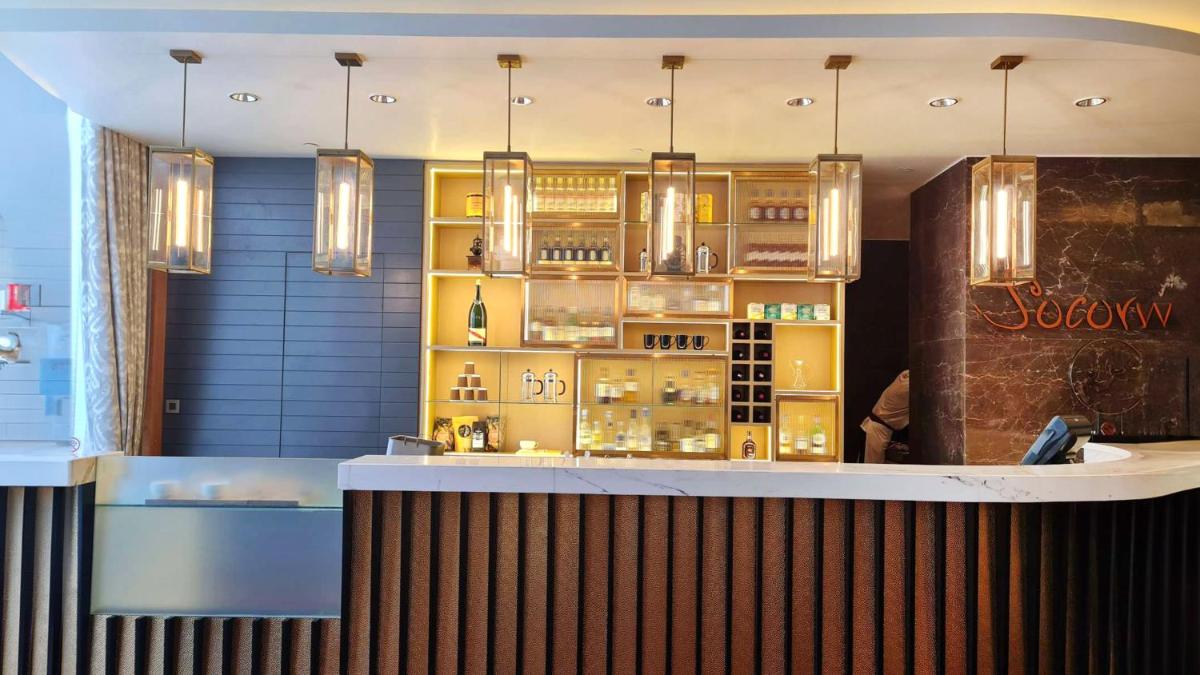 a bar in a restaurant with yellow cabinets at InterContinental Jaipur Tonk Road by IHG in Jaipur