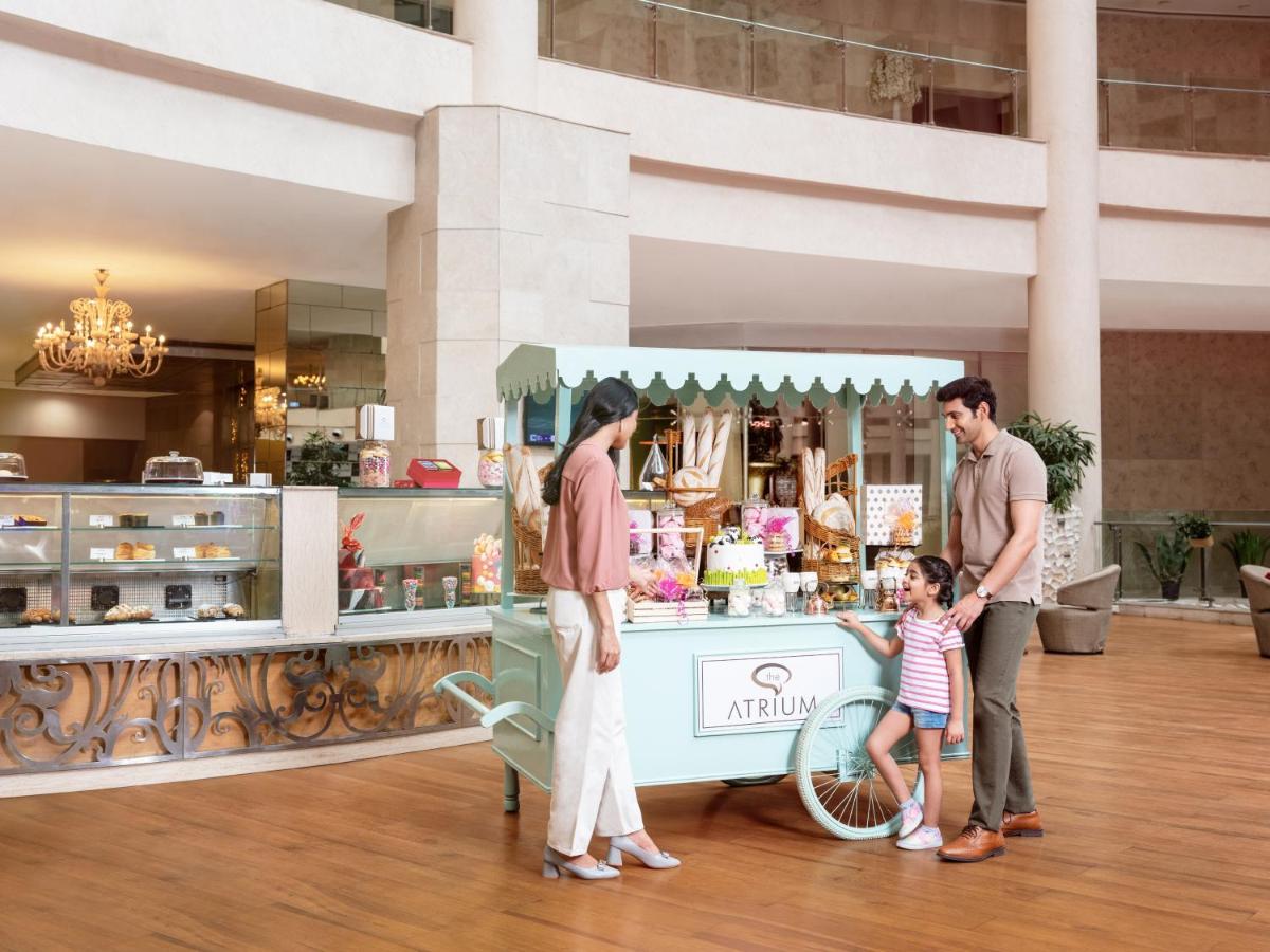 a family standing in front of a food cart at Radisson Blu Hotel New Delhi Dwarka in New Delhi a family standing in front of a food cart at Radisson Blu Hotel New Delhi Dwarka in New Delhi