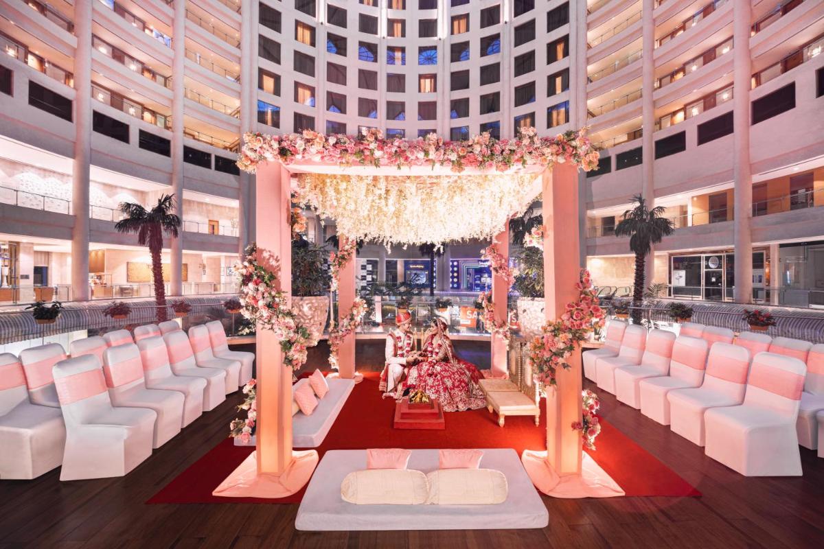a wedding ceremony in the middle of a building at Radisson Blu Hotel New Delhi Dwarka in New Delhi a wedding ceremony in the middle of a building at Radisson Blu Hotel New Delhi Dwarka in New Delhi