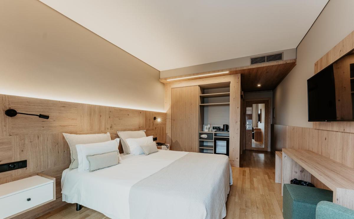 Uma cama ou camas num quarto em Hotel Minho