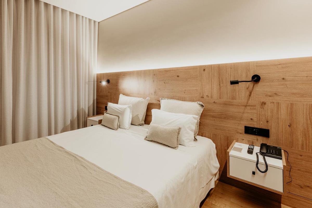 Uma cama ou camas num quarto em Hotel Minho