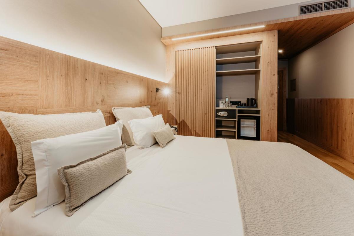 Uma cama ou camas num quarto em Hotel Minho