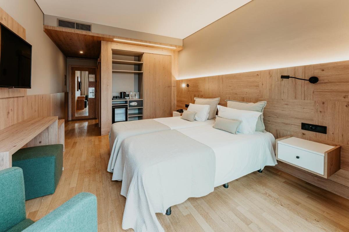 Uma cama ou camas num quarto em Hotel Minho
