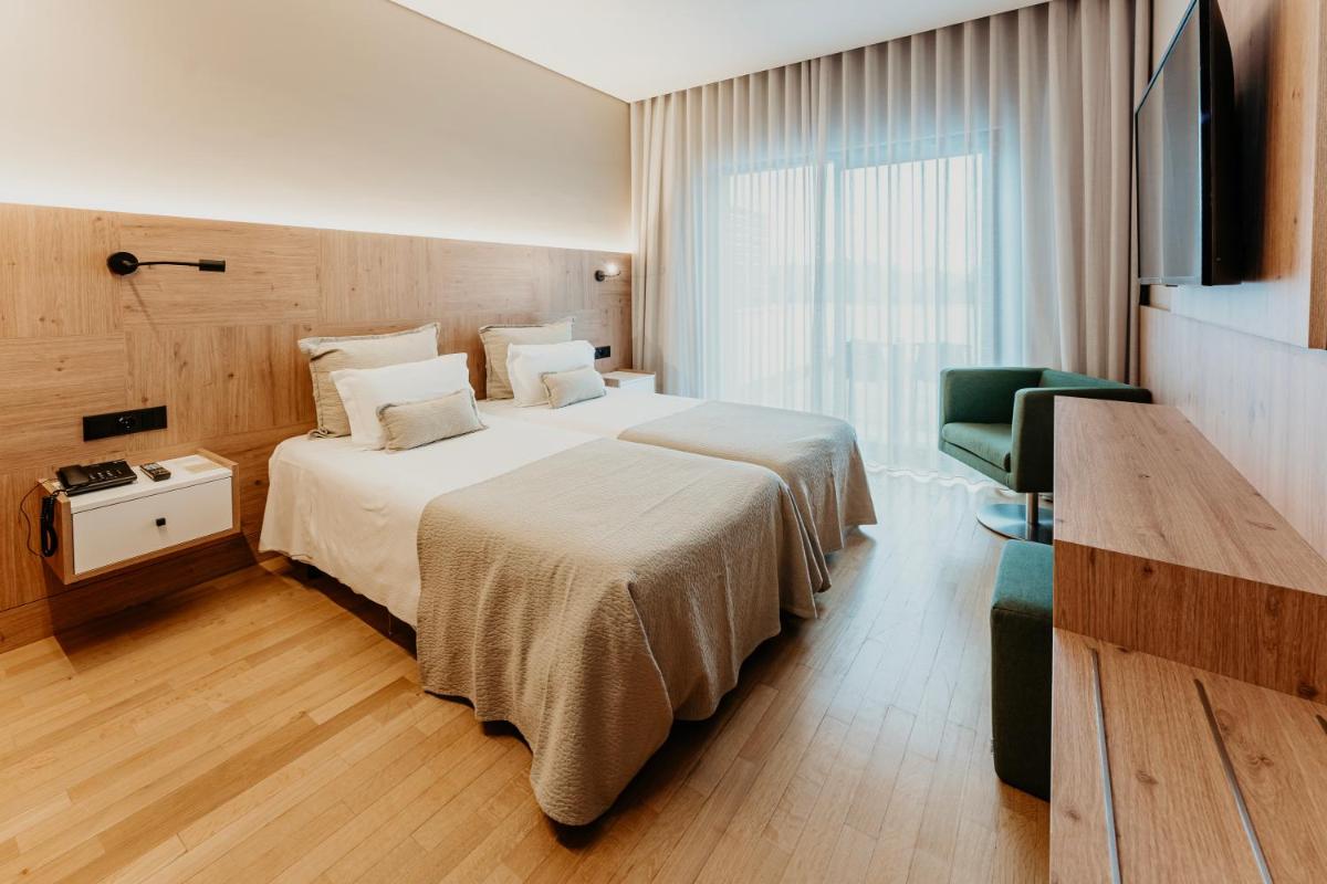 Uma cama ou camas num quarto em Hotel Minho