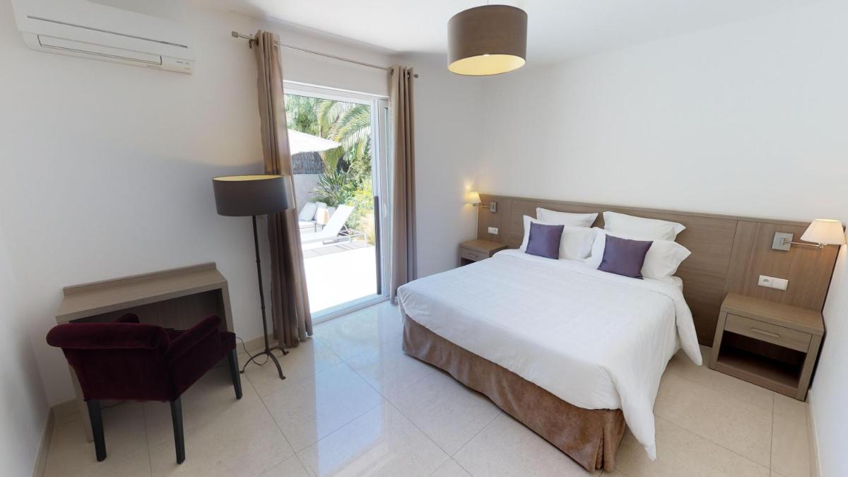 Un ou plusieurs lits dans un hébergement de l'établissement Domaine Villas Mandarine Private Pools & Spa