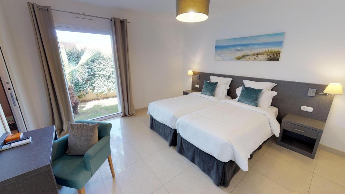 Un ou plusieurs lits dans un hébergement de l'établissement Domaine Villas Mandarine Private Pools & Spa