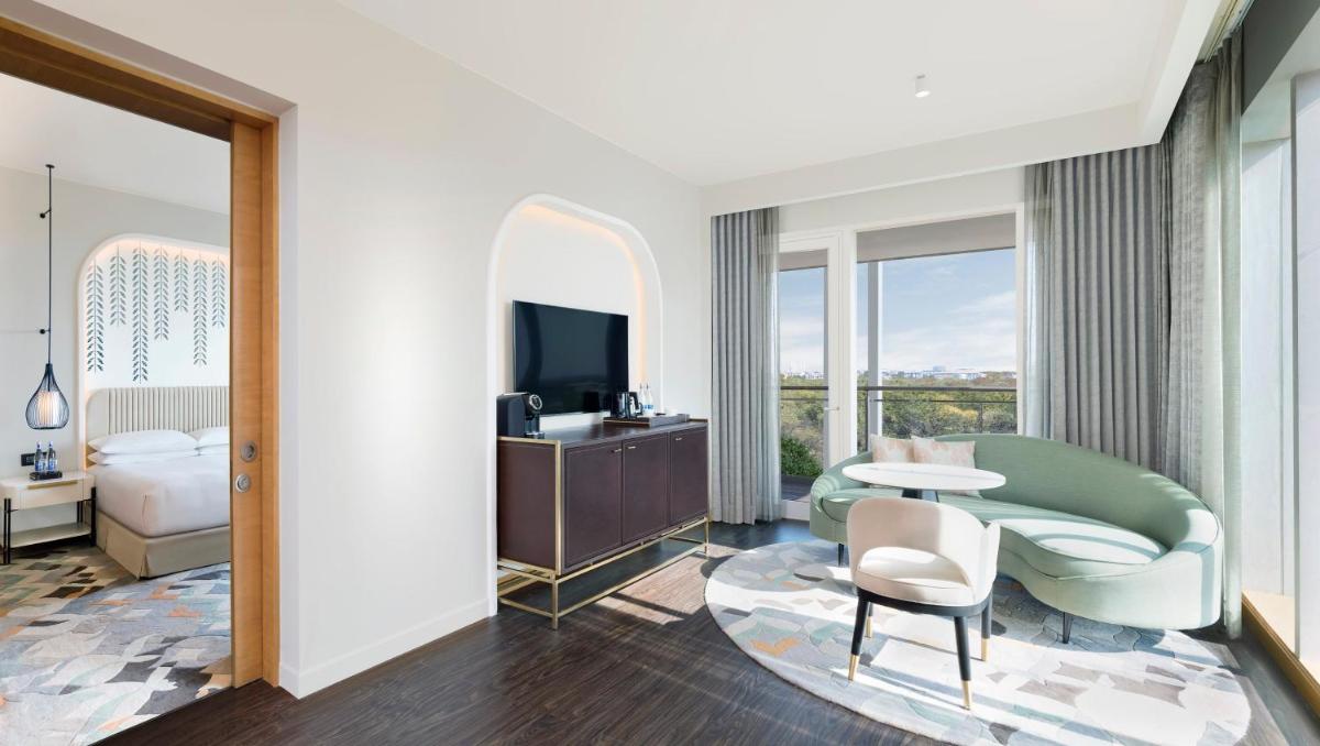a hotel room with a bed and a mirror at InterContinental Jaipur Tonk Road by IHG in Jaipur