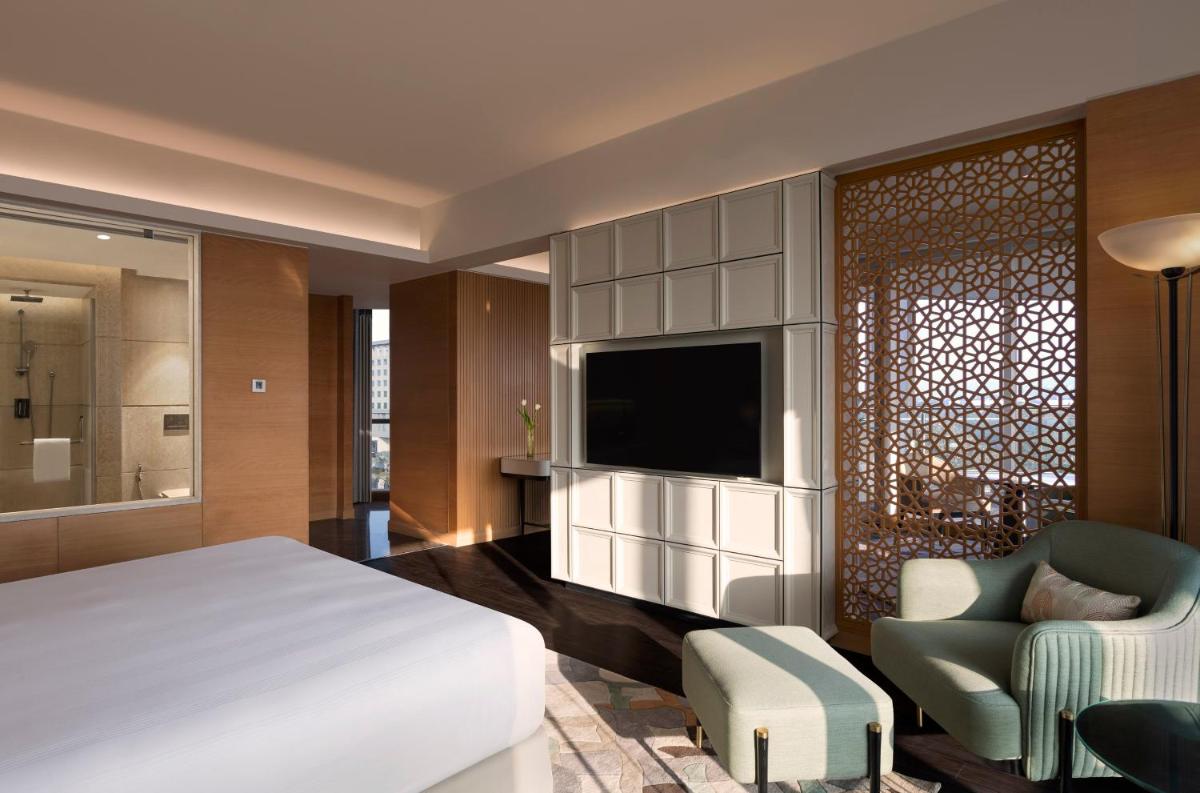 a hotel room with a bed and a television at InterContinental Jaipur Tonk Road by IHG in Jaipur