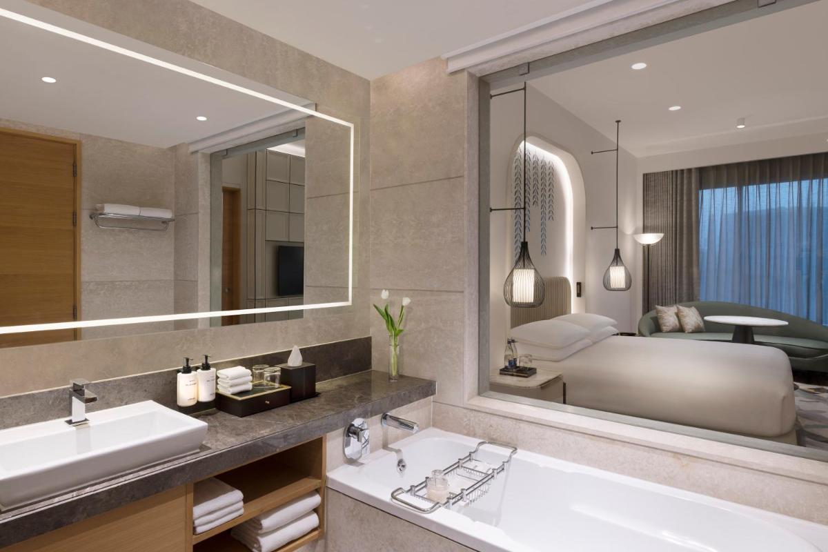 a bathroom with two sinks and a large mirror at InterContinental Jaipur Tonk Road by IHG in Jaipur