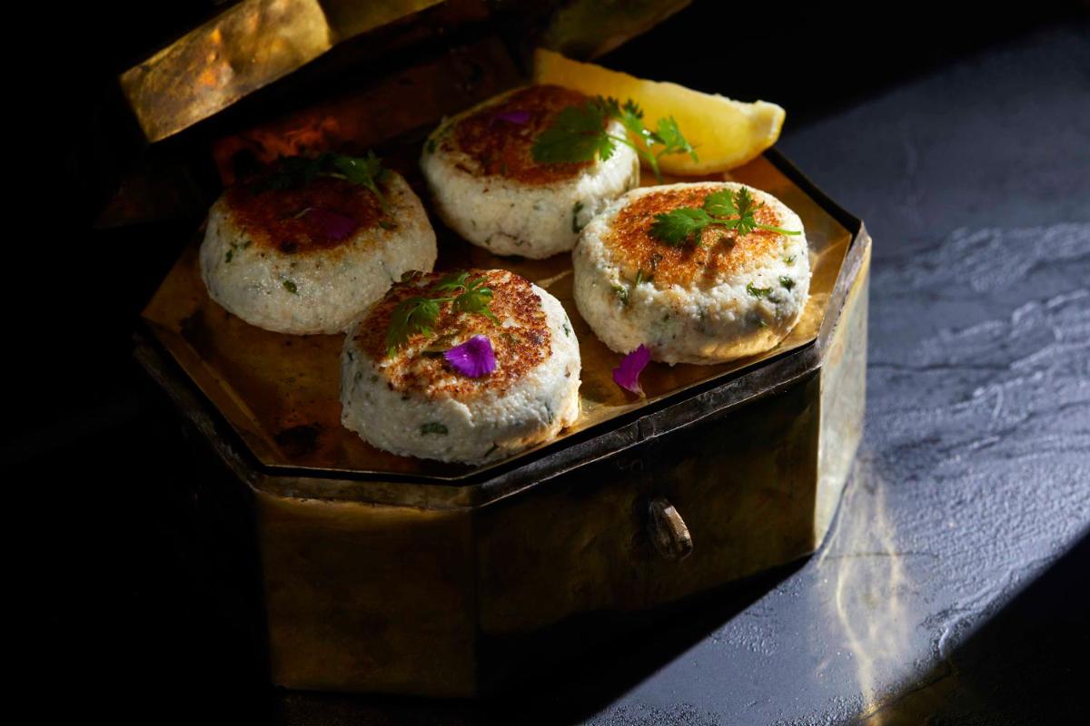 a wooden box with four donuts with sprinkles at JW Marriott Mumbai Juhu in Mumbai