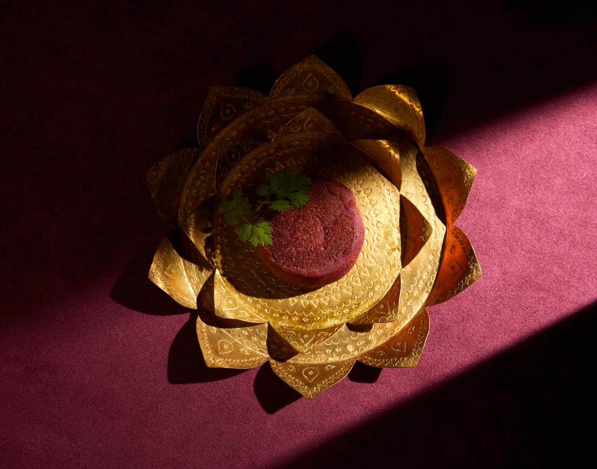 a gold flower on top of a pink surface at JW Marriott Mumbai Juhu in Mumbai