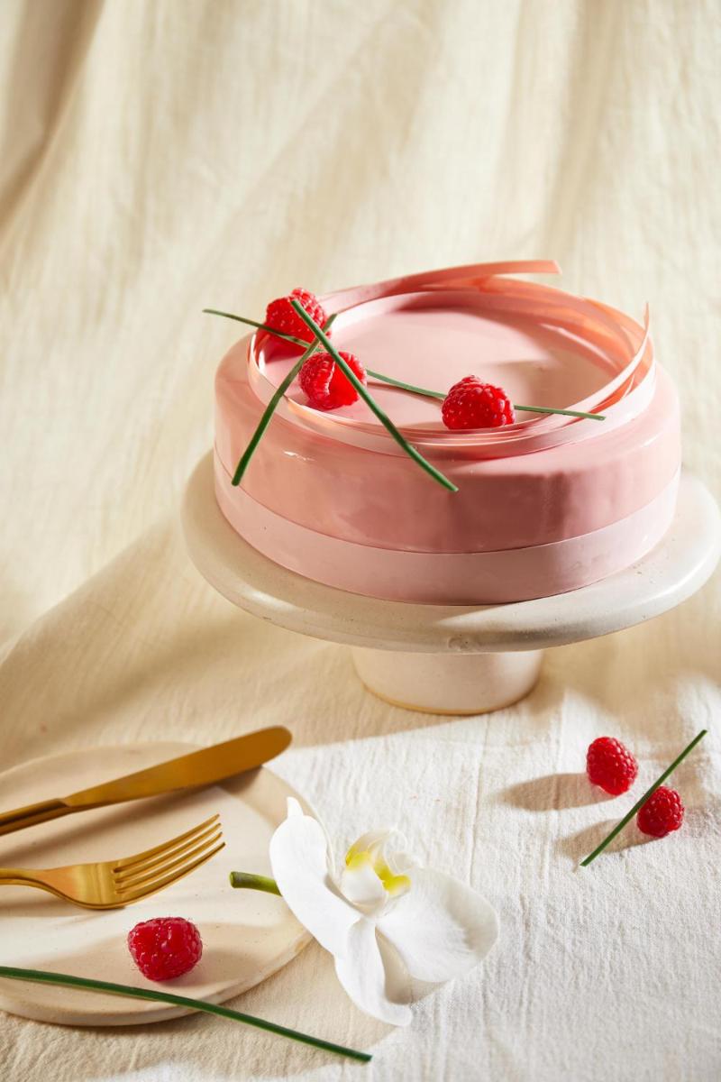 a pink cake on a plate on a table at JW Marriott Mumbai Juhu in Mumbai