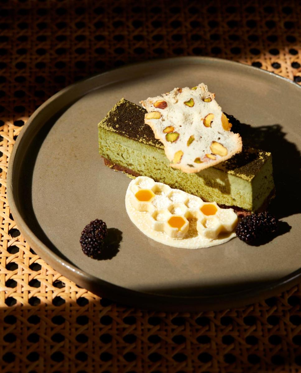 a plate with a piece of cake and a piece ofecake at JW Marriott Mumbai Juhu in Mumbai