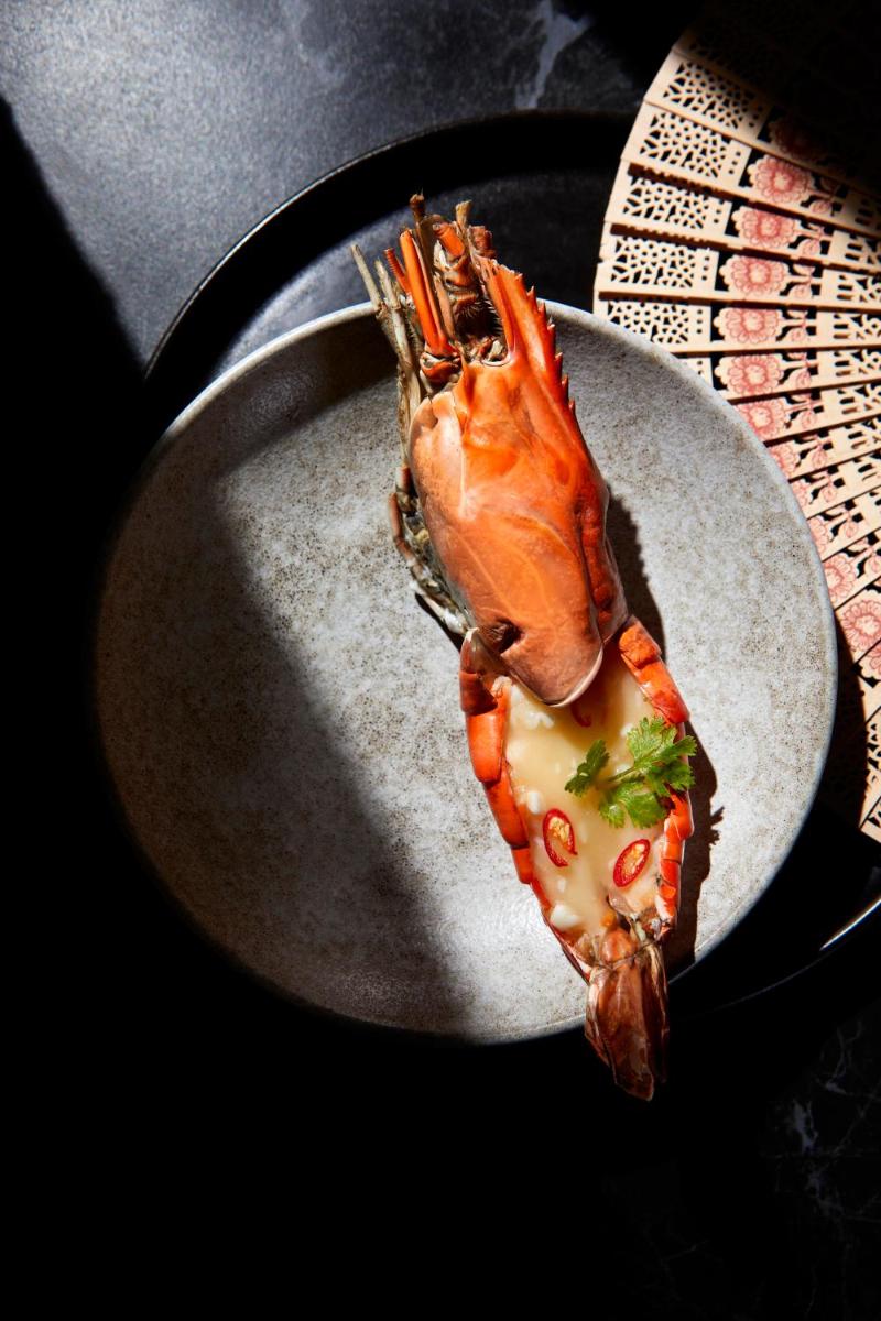 a lobster on a plate on a table at JW Marriott Mumbai Juhu in Mumbai