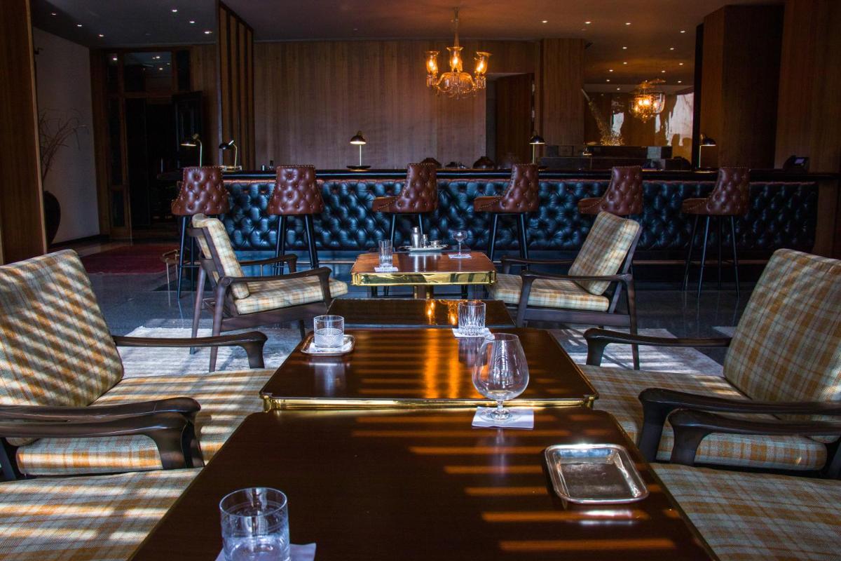 a restaurant with tables and chairs and a bar at Grand Hyatt Gurgaon in Gurgaon +98 photos