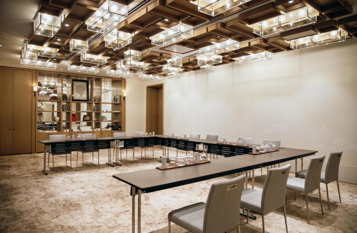 a large room with tables and chairs and lights at Grand Hyatt Gurgaon in Gurgaon