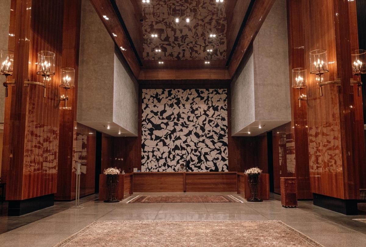 a lobby with a wall with a chandelier at Grand Hyatt Gurgaon in Gurgaon