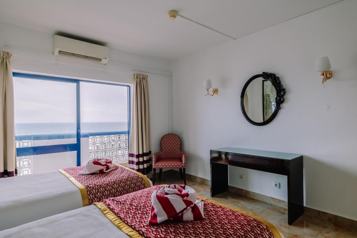 Uma cama ou camas num quarto em Grand Muthu Oura View Beach Club