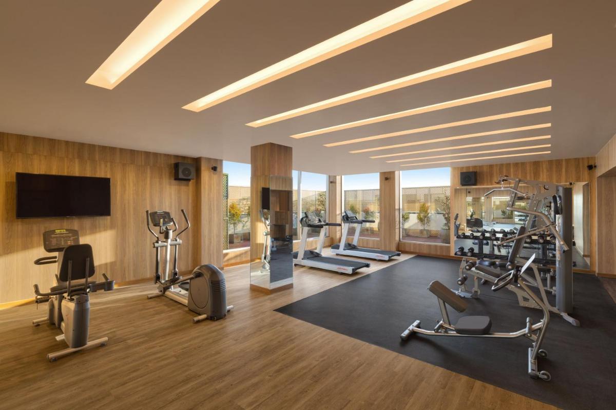 a gym with treadmills and cardio equipment in a building at Courtyard by Marriott Tiruchirappalli in Tiruchchirāppalli