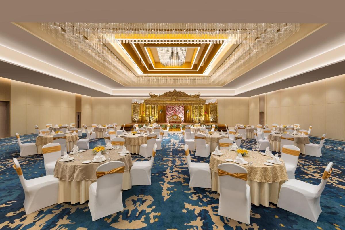 a banquet hall with tables and chairs in a room at Courtyard by Marriott Tiruchirappalli in Tiruchchirāppalli +54 photos