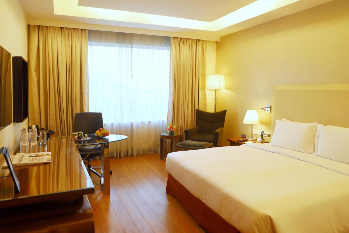 a hotel room with a bed and a window at DoubleTree by Hilton Gurgaon New Delhi NCR in Gurgaon